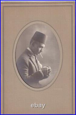 Armenian photographer in EGYPT HANDSOME MAN LIGHTS a cigarette. PHOTO LONDON