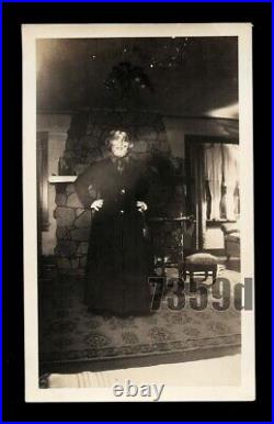Creepy Old Snapshot Woman Wearing Halloween Mask in Dark Room VTG Photo
