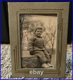 Old Baby Photo In Unique Photo Frame Stand Made Of Leather Or Something Similar
