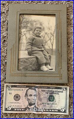 Old Baby Photo In Unique Photo Frame Stand Made Of Leather Or Something Similar